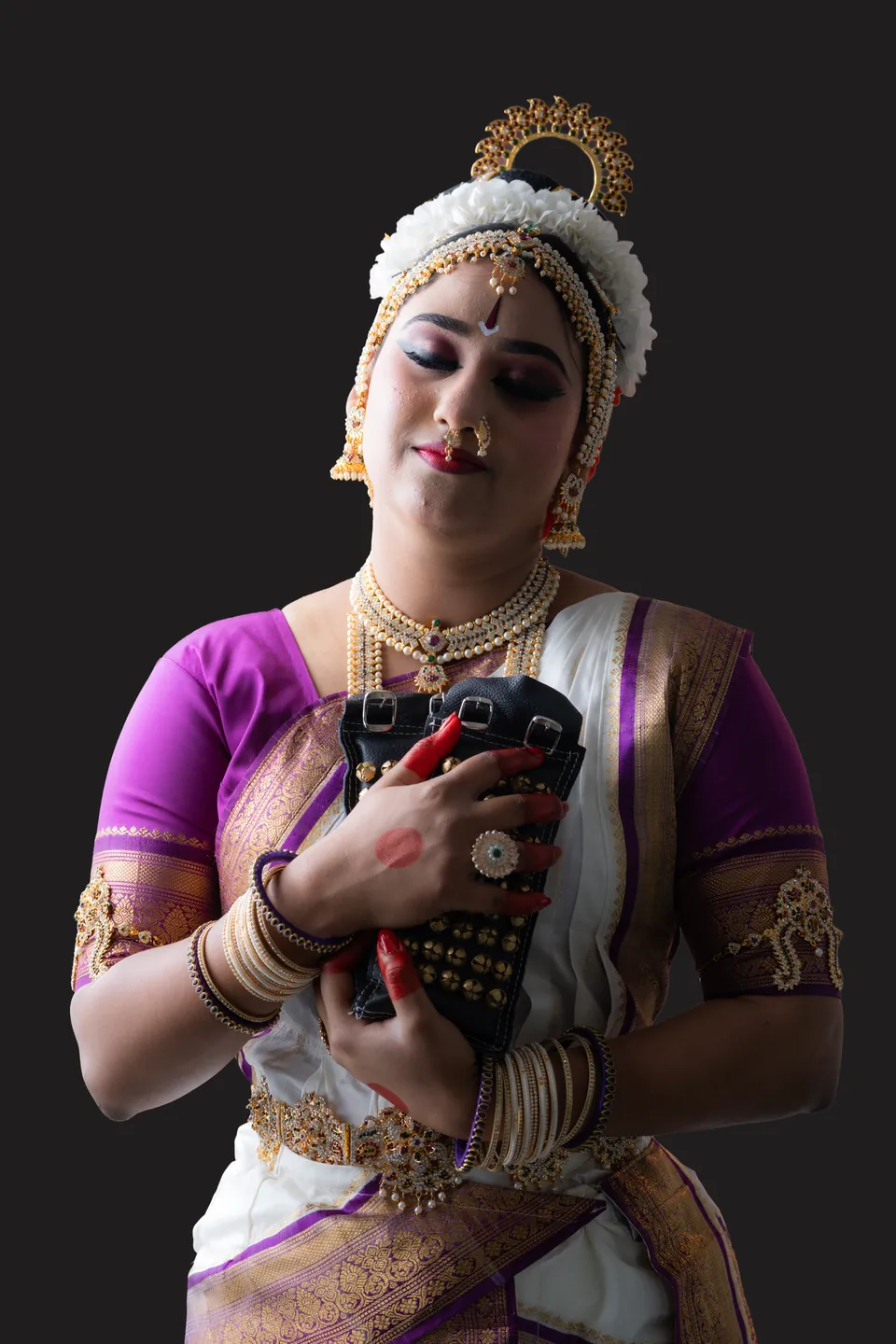 Classical dancer in purple and white holding an expressive hand gesture