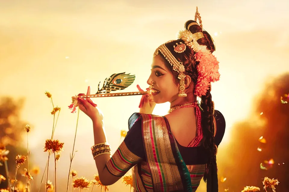 Classical dancer holding a flute in a sunlit field of flowers