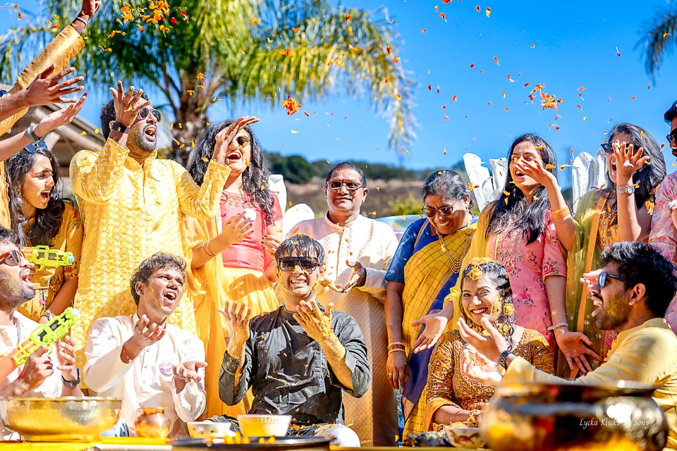 Guests throwing flower petals during a joyful turmeric celebration