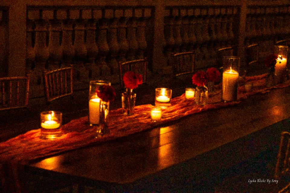 Candlelit reception table with flowers and glasses